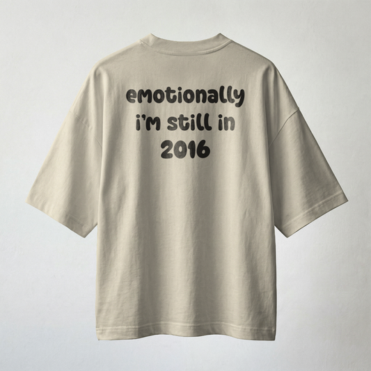 Beige oversized t-shirt with “emotionally i’m still in 2016” text minimal aesthetic