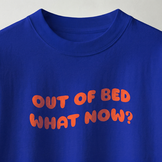 Close-up of “out of bed what now?” text on blue oversized t-shirt