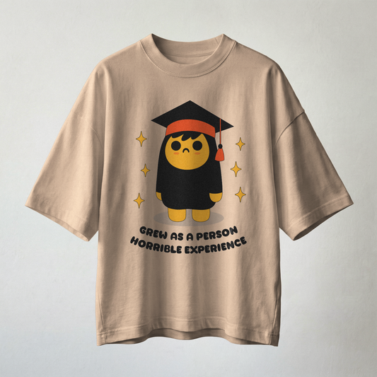 Woman wearing beige oversized t-shirt with funny graduation quote graphic