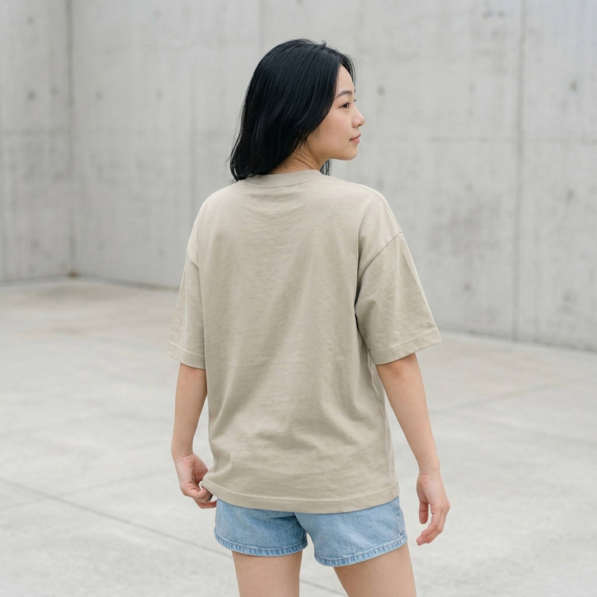 Woman wearing beige oversized t-shirt back view relaxed fit casual look