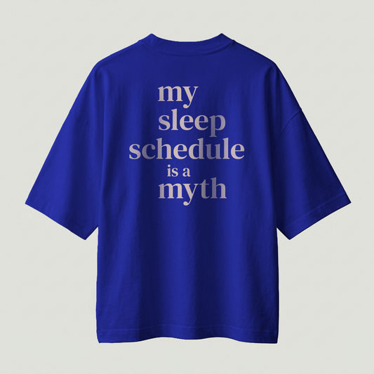 Blue oversized t-shirt with “my sleep schedule is a myth” text on back