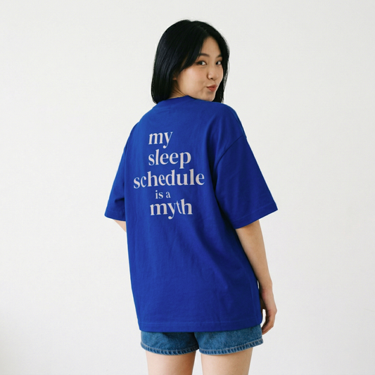 Woman wearing blue oversized t-shirt with text on back casual aesthetic