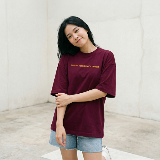 Woman wearing burgundy oversized t-shirt with playful text relaxed casual look
