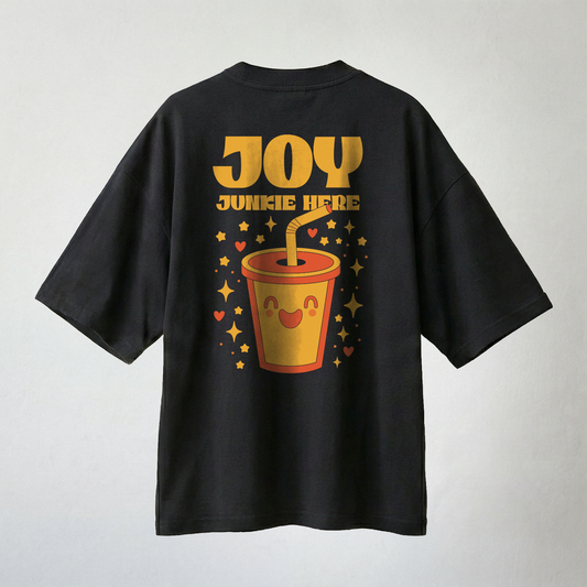 Black oversized t-shirt with “Joy Junkie Here” text and cute happy drink graphic on back