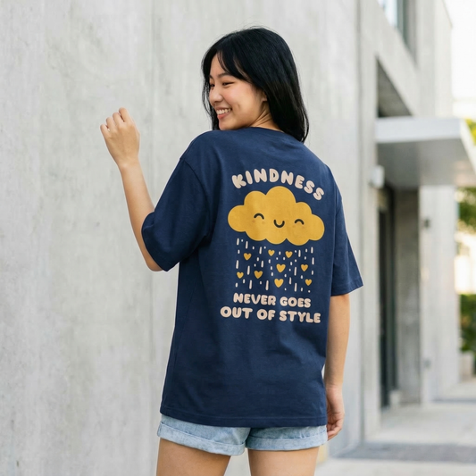 Woman wearing navy oversized t-shirt with kindness quote and cute cloud graphic on back