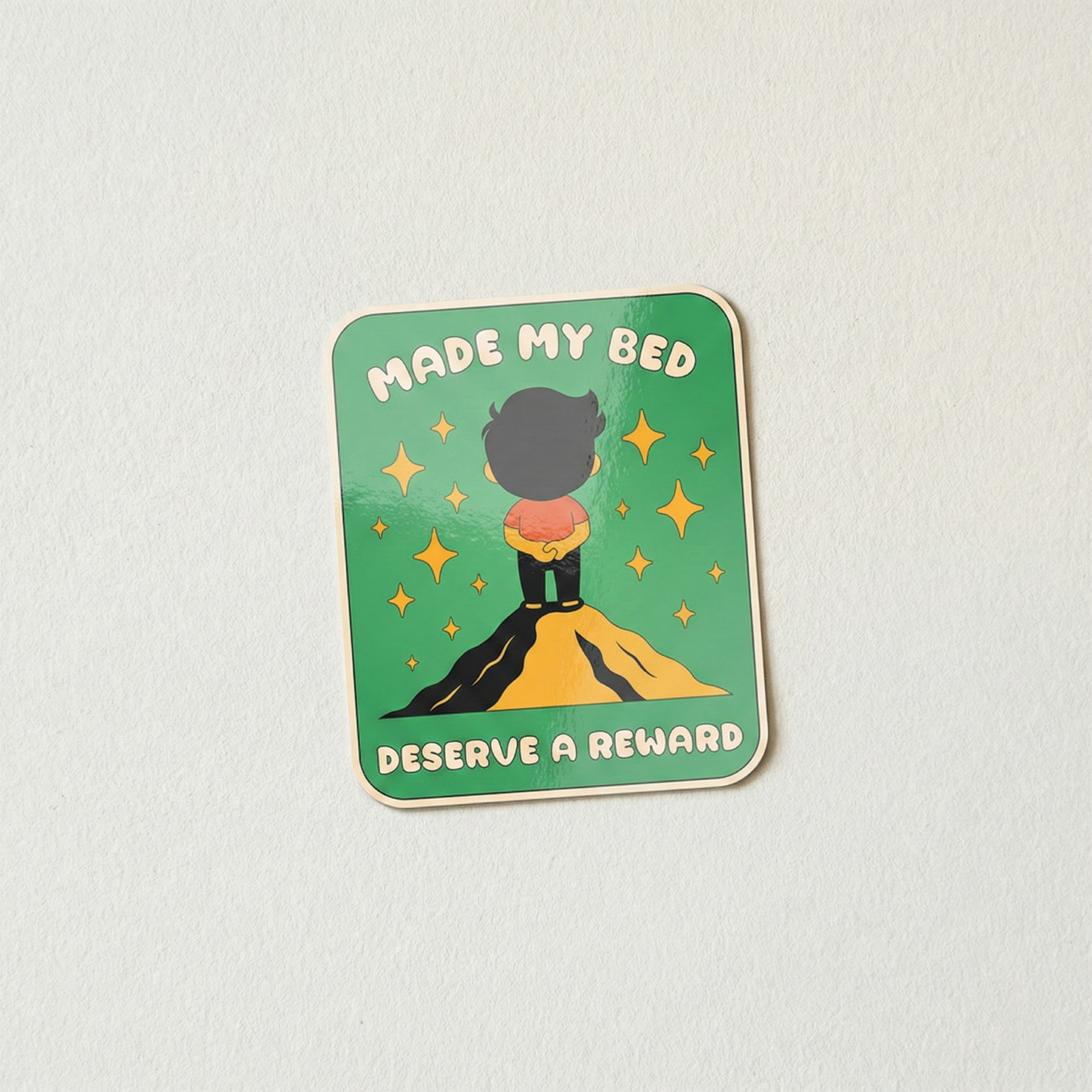 Made My Bed Deserve a Reward funny relatable vinyl sticker with character standing proudly on hill