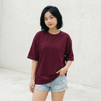 Woman wearing maroon oversized t-shirt front view relaxed fit minimal premium look