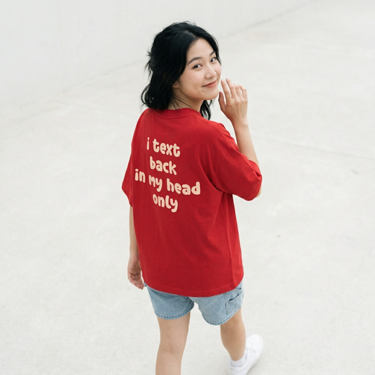 Woman wearing red oversized t-shirt back view with text print relaxed fit casual streetwear