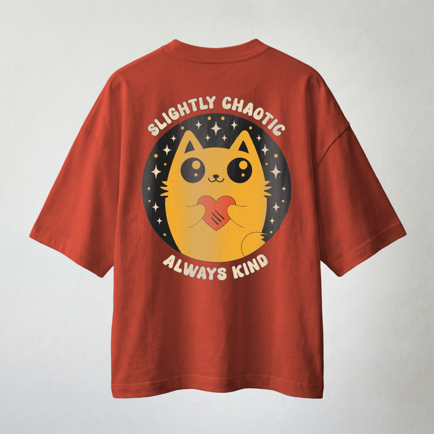 Rust red oversized t-shirt with cute cat holding heart and “Slightly Chaotic Always Kind” back print